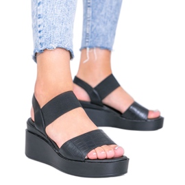 Sandales compensées noires de Wins le noir