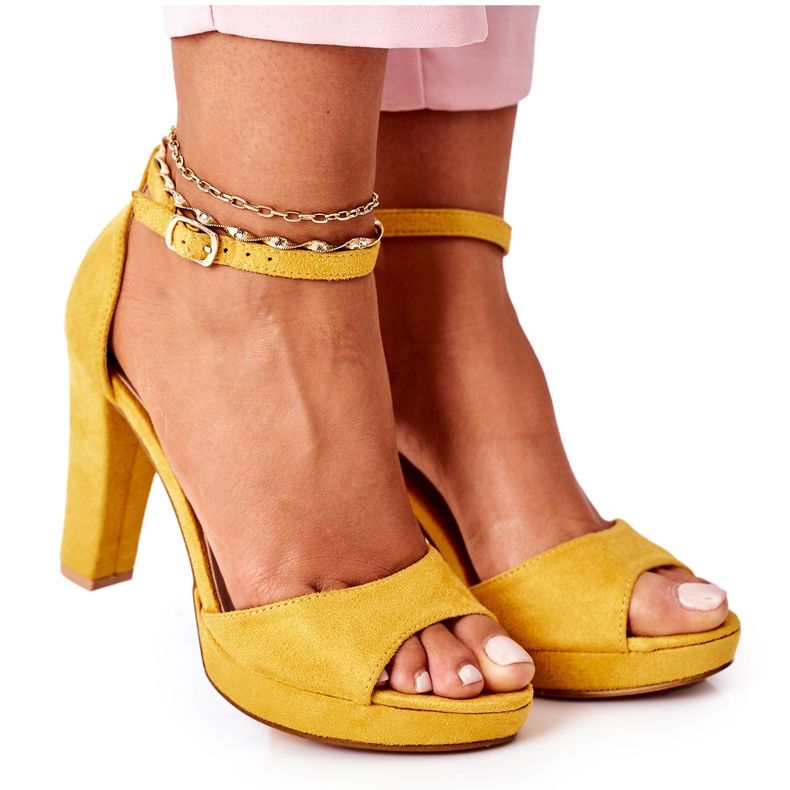 Sandales en daim des femmes sur le post jaune