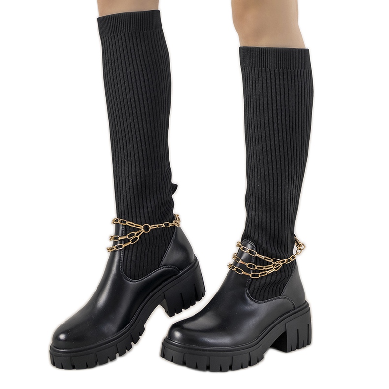 Bottes noires avec une tige de chaussette le noir