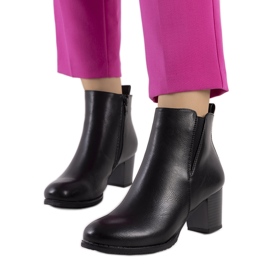 Bottes noires sur le poste du mendiant le noir