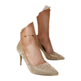 Talons hauts dorés brillants avec semelle intérieure en cuir d'or Talons hauts dorés brillants avec semelle intérieure en cuir d'or