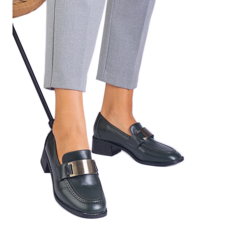 Chaussures vertes sur un poteau bas avec une décoration métallique