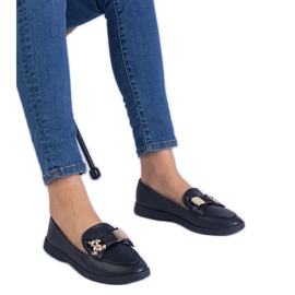 Muisseurs noirs décorés d'un arc et d'un ours en peluche doré