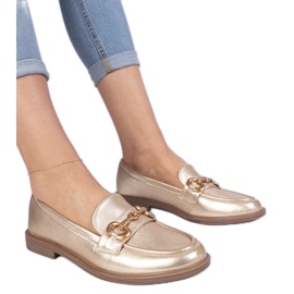 Mocassins féminins dorés avec décoration dorée