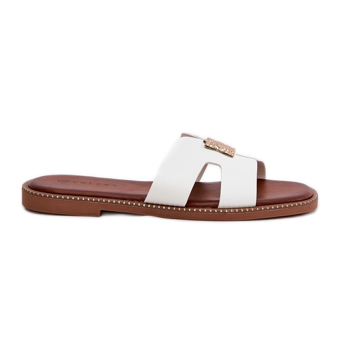Les tongs plats avec des découpes et une décoration blanche