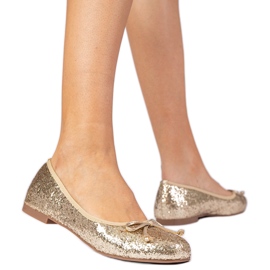 Ballerines scintillantes féminines dorées avec un arc d'or