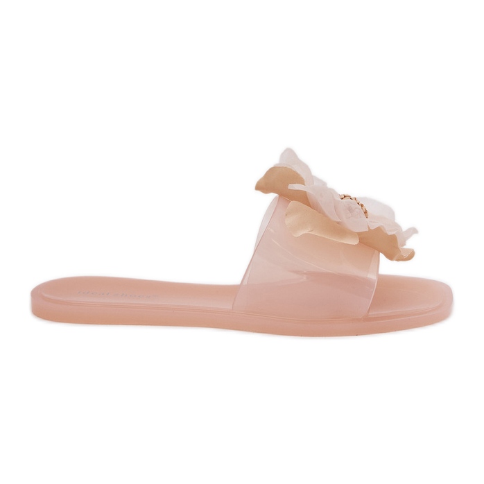 Les tongs des femmes plates transparentes avec une fleur de nu artificielle beige
