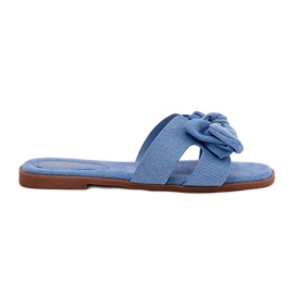 Les tongs plats des femmes avec un arc bleu