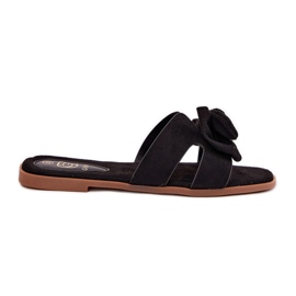 Les tongs plats des femmes avec un arc noir le noir