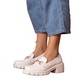 Chaussures blanches sur un poteau bas avec un ornement doré