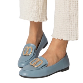 Mocassins des femmes bleues avec une décoration dorée Mocassins des femmes bleues avec une décoration dorée