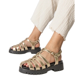 Sandales en or sur la plate-forme avec une ligne de doigt construite doré