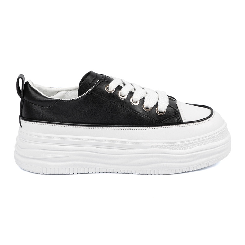 Baskets en noir et blanc sur la plate-forme le noir