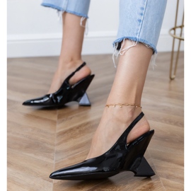 Sandales noires sur un coin géométrique