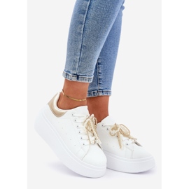 Baskets pour femmes sur la plate-forme avec des décorations blanches et or 1
