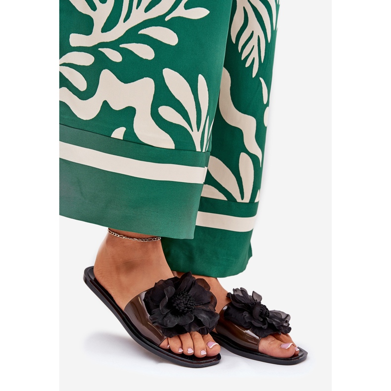 Les tongs des femmes plates transparentes avec un noir de fleur artificielle le noir 1 Les tongs des femmes plates transparentes avec un noir de fleur artificielle le noir 1