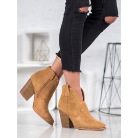 Bottes de cowboy en daim sur le pilier beige 2