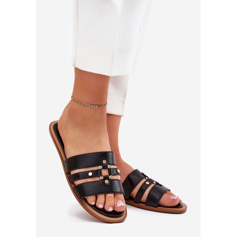 Les tongs plats des femmes avec des détails dorés noirs le noir 1 Les tongs plats des femmes avec des détails dorés noirs le noir 1