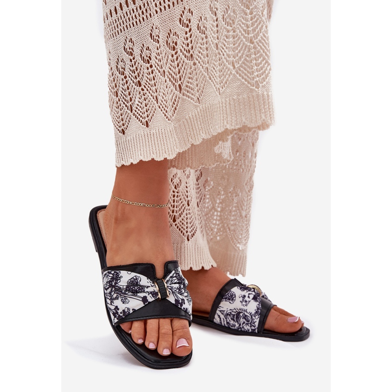 Les tongs des femmes à thèmes plates avec un arc noir 1