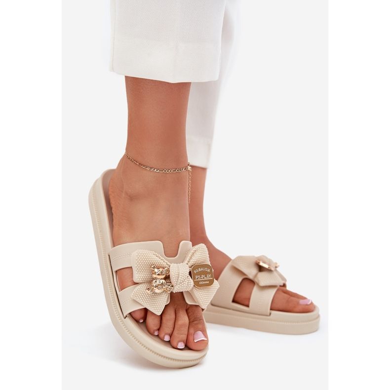 Les tongs des femmes avec un arc et une broche en bouillie brillante dorée beige 1 Les tongs des femmes avec un arc et une broche en bouillie brillante dorée beige 1