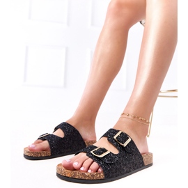 Les tongs des paillettes noires sur la semelle en liège de la flotte le noir 1