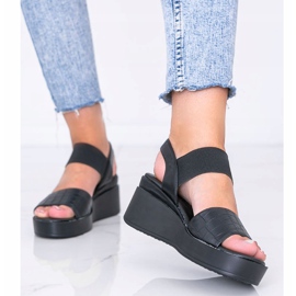 Sandales compensées noires de Wins le noir 1